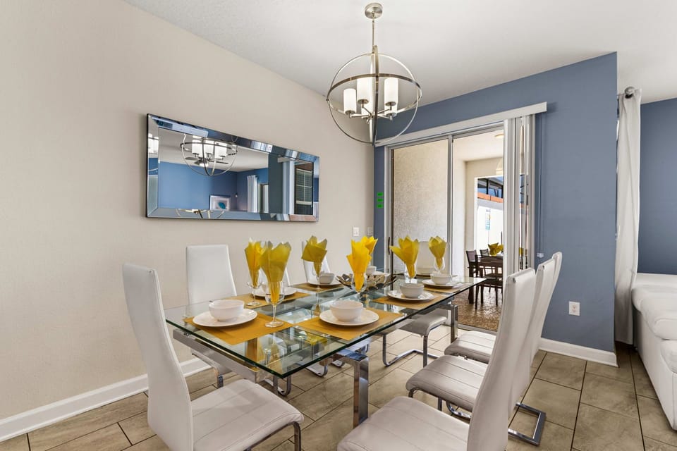 Stylish kitchen with white cabinets, stainless steel appliances, and a cozy breakfast bar. Great for cooking and casual dining!