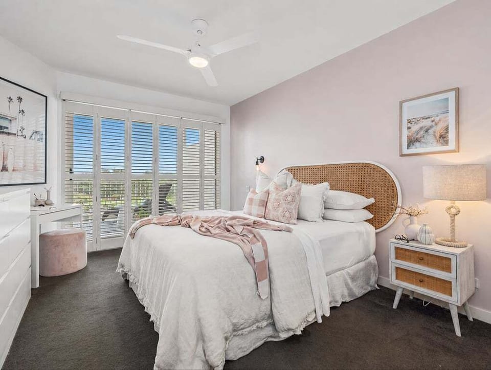 Soft linens, cozy comforts, and a sleek little vanity corner dedicated to the ultimate 'Get Ready With Me' routine. Welcome to the master bedroom.