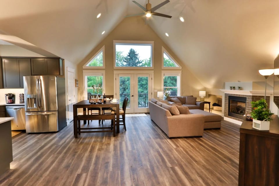 Vaulted ceilings and large windows fill the great room with natural light.
