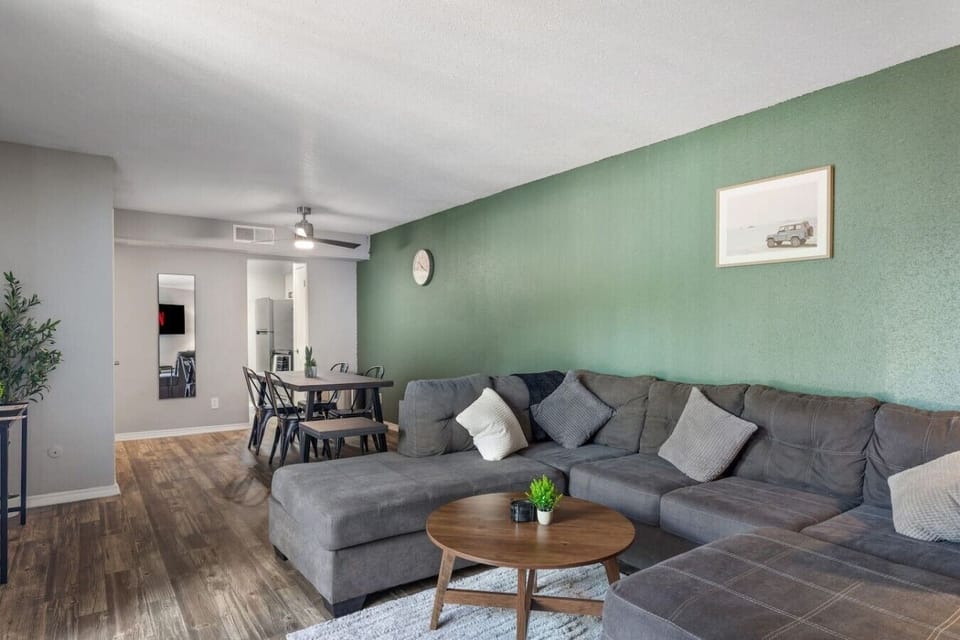 Spacious and inviting living area with comfortable seating and a smart TV, perfect for relaxing after exploring Arlington or attending events at AT&T Stadium.