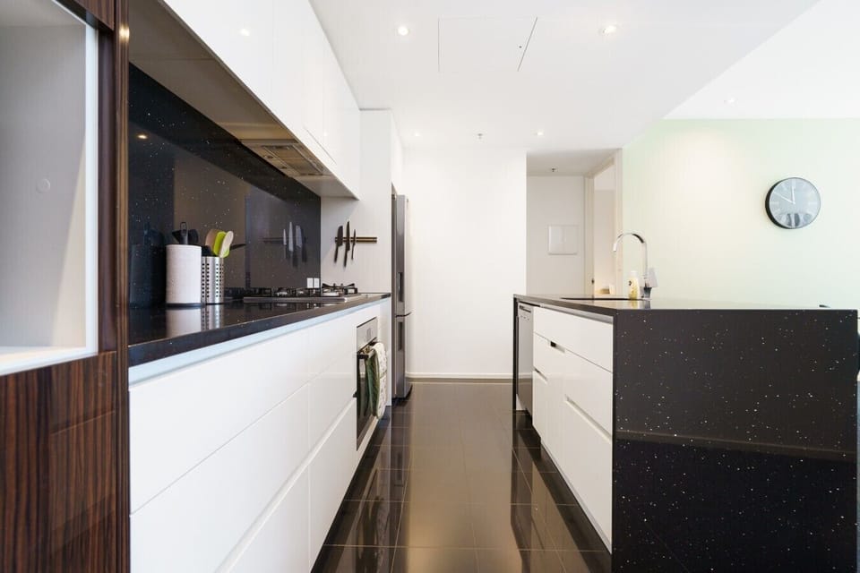 The sleek, modern kitchen is fully equipped for everything from quick breakfasts to relaxed dinners at home.