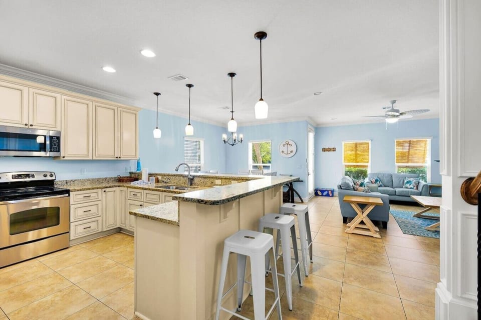 Sunlight floods this open kitchen, making every morning here feel like a fresh start.