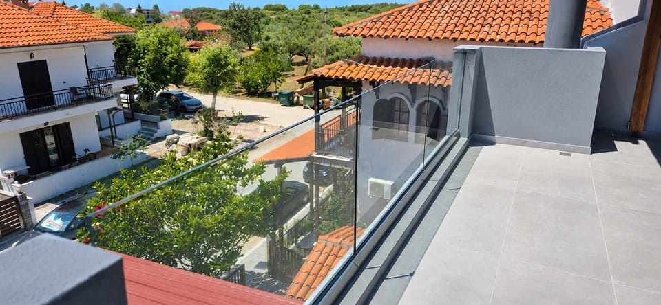 Spacious Balcony Terrace with Glass Railings and Village Views