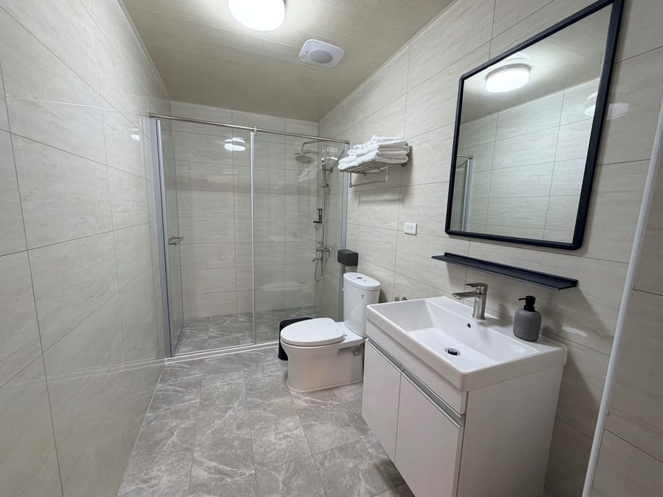 Shower, hair dryer, slippers, towels