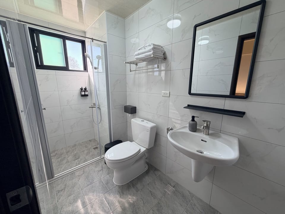 Shower, hair dryer, slippers, towels