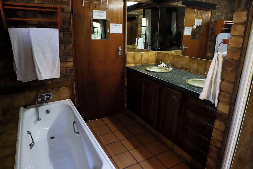 Junior Apartment, Patio, Garden View | Bathroom | Separate tub and shower, free toiletries, hair dryer, towels