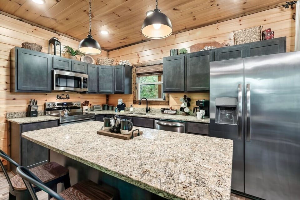 The oversized kitchen island offers plenty of room for cooking gathering and connecting making it the heart of the cabin.