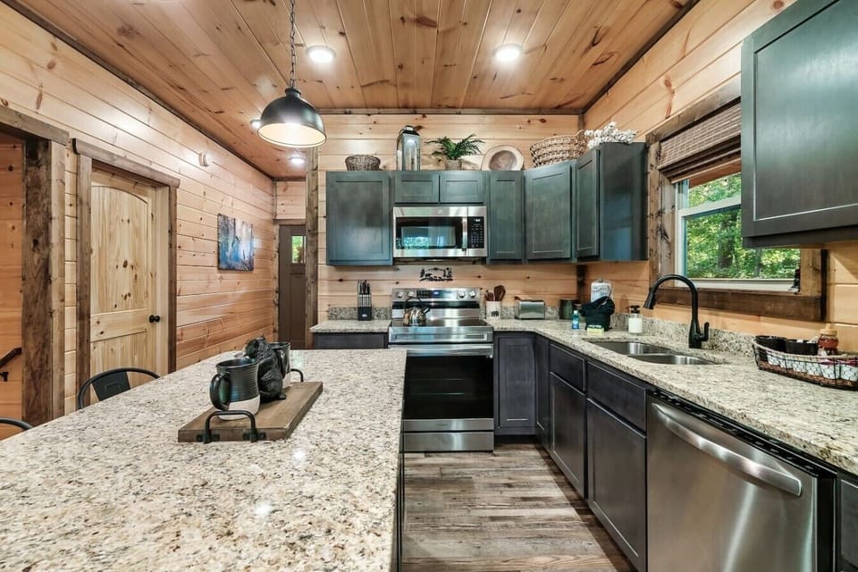Prepare everything from quick breakfasts to family dinners in this spacious kitchen featuring granite countertops stainless steel appliances and a large island.