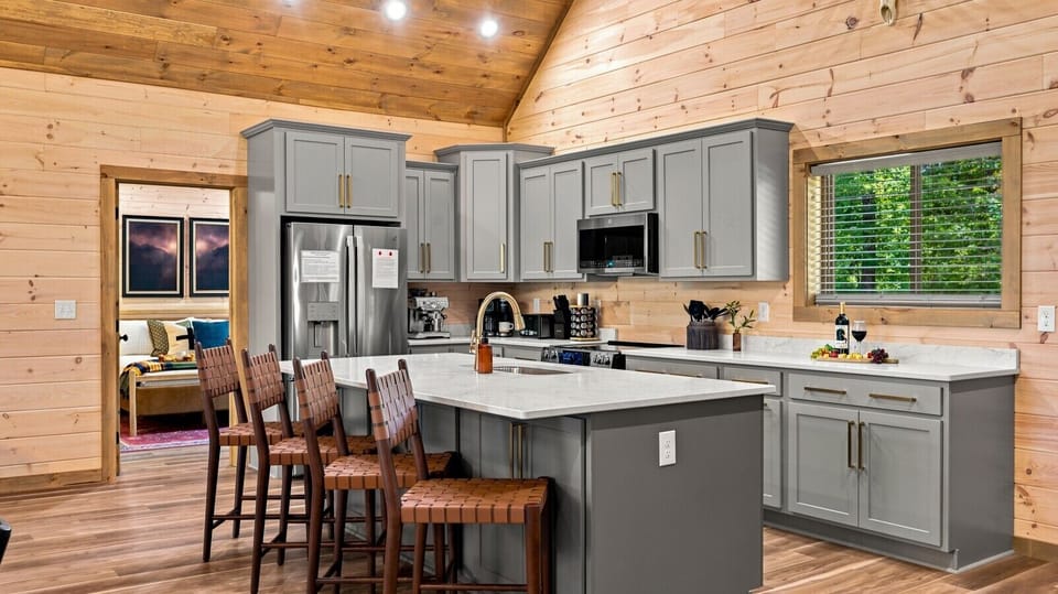 The gourmet kitchen offers abundant prep space, generous storage, and seating for the whole group, making everything from holiday meals to late-night snacks effortless.