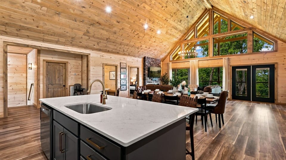 The spacious open layout seamlessly connects the kitchen, dining, and living areas, making it easy for everyone to gather while still having plenty of room to spread out.