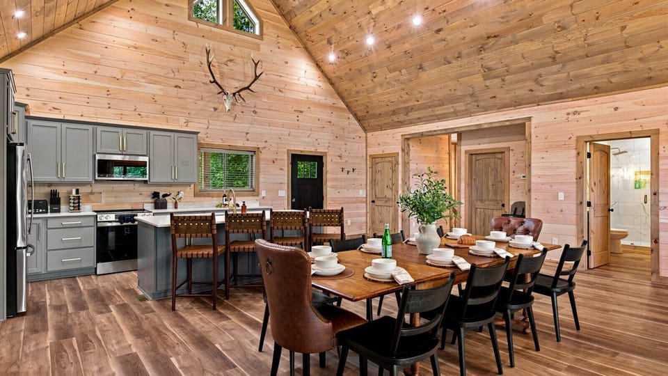 Soaring vaulted ceilings, warm wood finishes, and modern amenities create a bright, inviting space that blends mountain charm with upscale comfort.