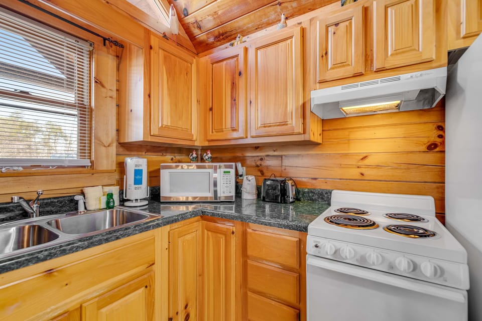 Kitchen, whip up delicious meals in this bright, pine-clad kitchen with modern appliances!