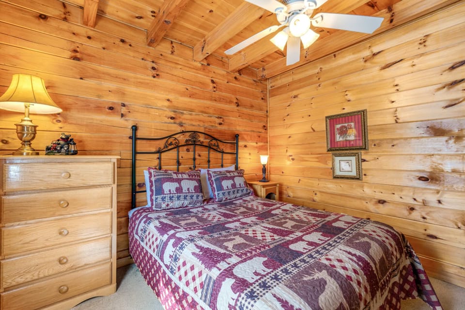 Embrace mountain charm in a serene wood-paneled haven adorned with cozy decor.