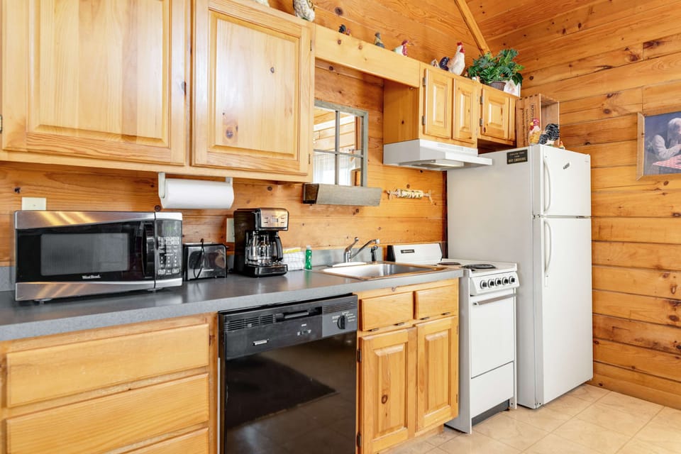 Whip up culinary delights in this charming, fully-equipped kitchen with warm wooden accents!