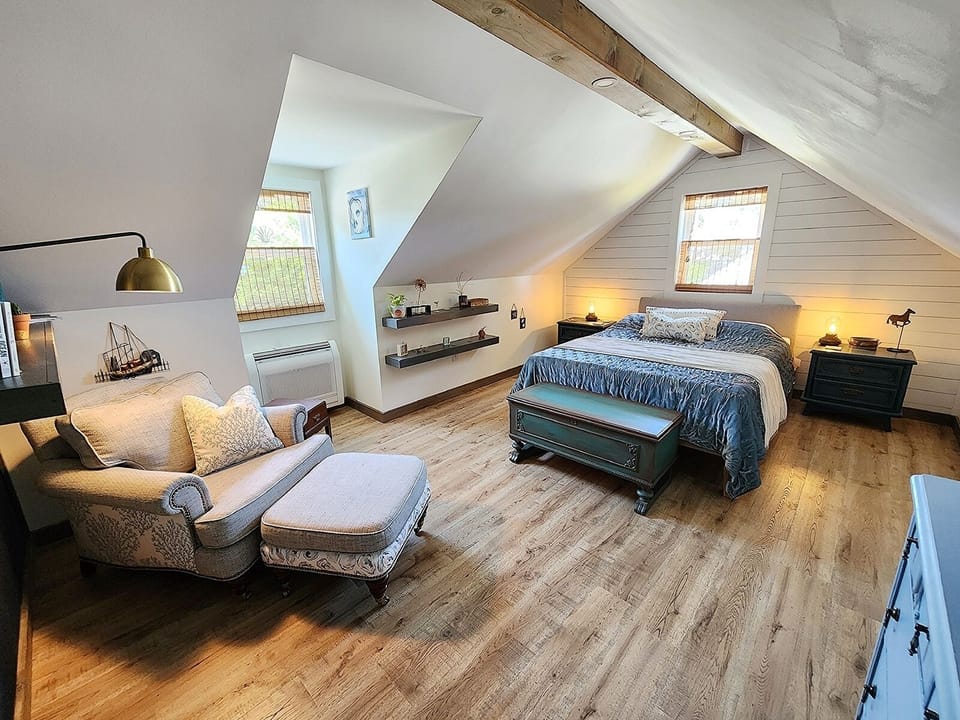 Upstairs, the primary suite provides a Queen bed and cozy sitting nook.