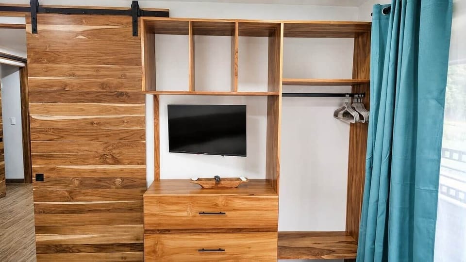 Unpack, settle in, and welcome home. The handcrafted teak armoire provides convenient storage for clothing and personal items throughout your time at Casa Isabella.