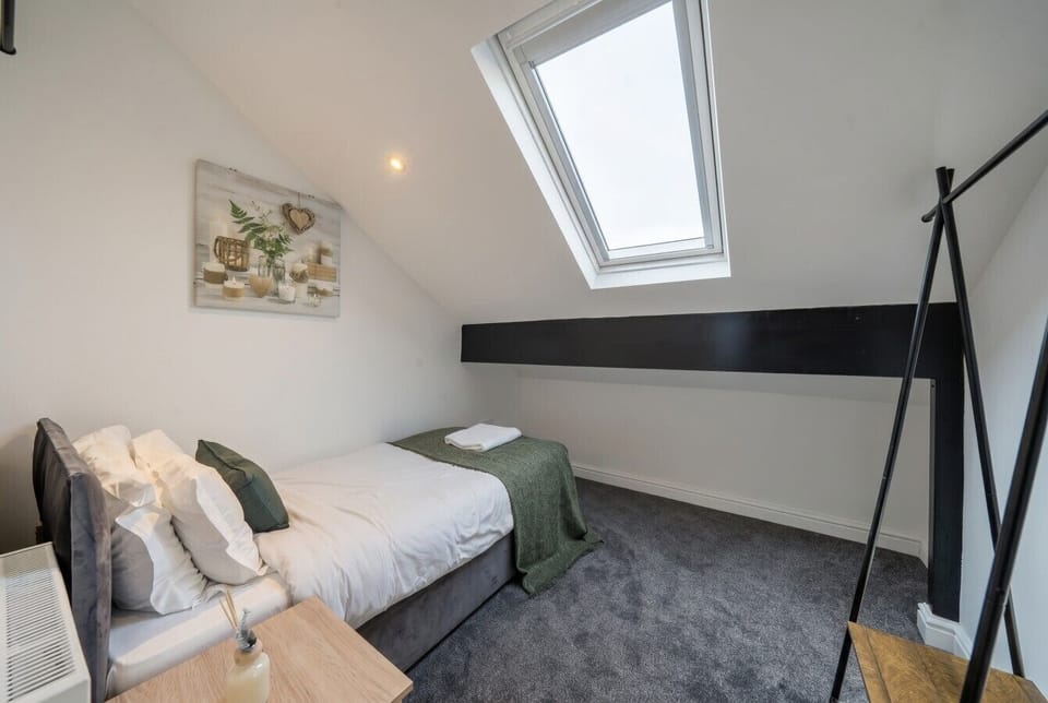 Peaceful single room bathed in natural skylight.