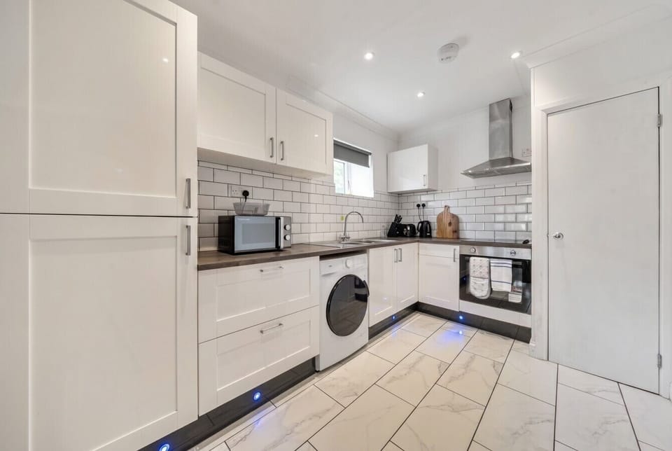 Sleek white kitchen with washer, oven and everything for easy self catering