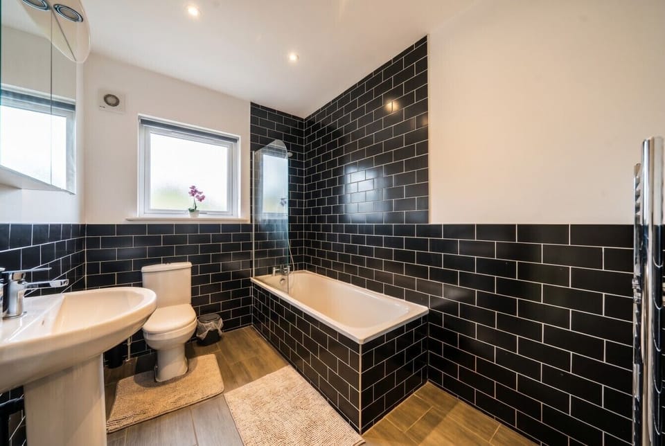 Stylish bathroom with deep tub and bold tiling for a relaxing soak