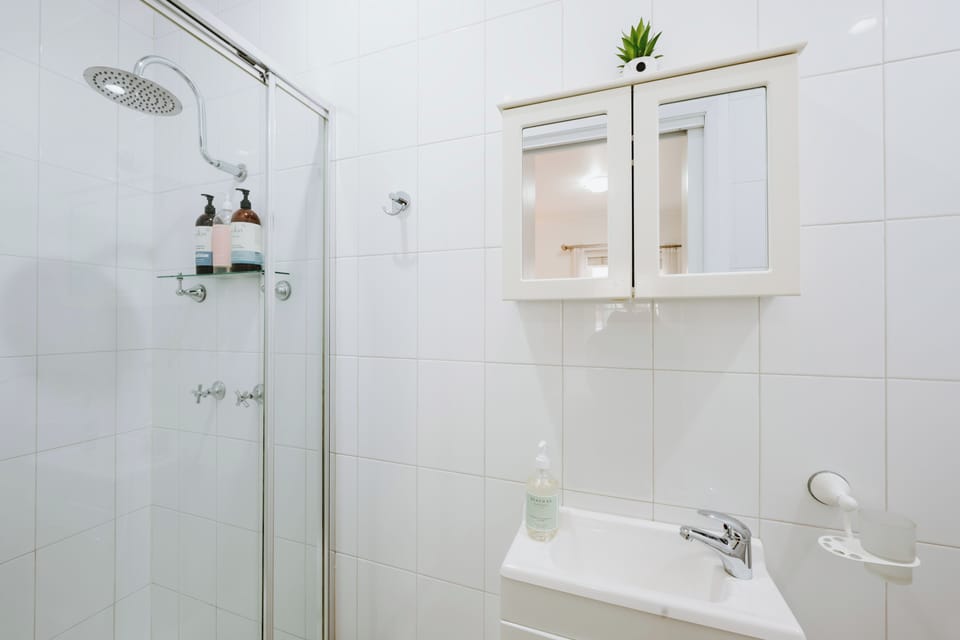 Refresh in the compact ensuite, where a walk-in shower and essentials provide a practical space to begin or end the day with ease.