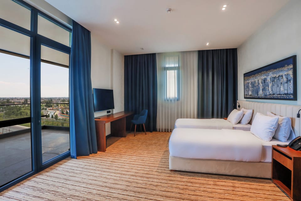 Junior Twin Room, Lanai | Minibar, in-room safe, laptop workspace, blackout drapes