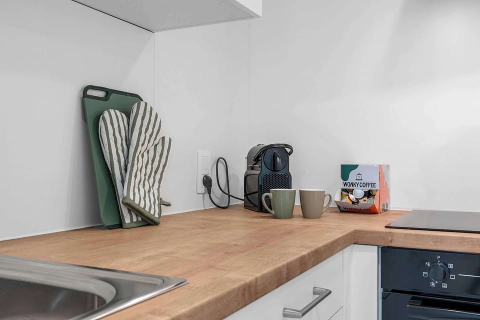 Bright kitchen with a wooden worktop, kettle and everyday essentials, fully equipped for self-catering in this 1-bedroom apartment in Knokke.