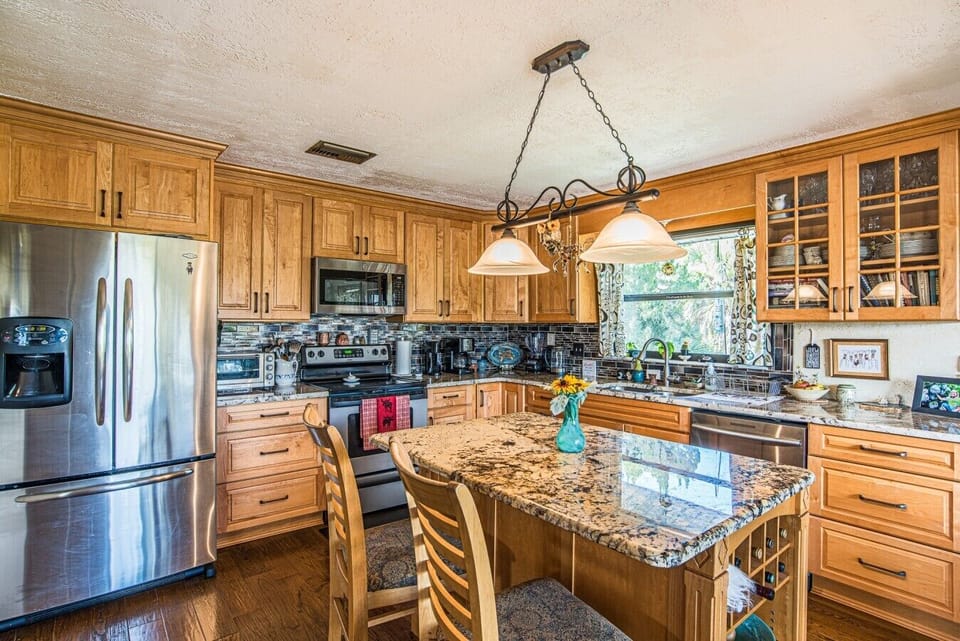 Full kitchen with breakfast bar and dining area
