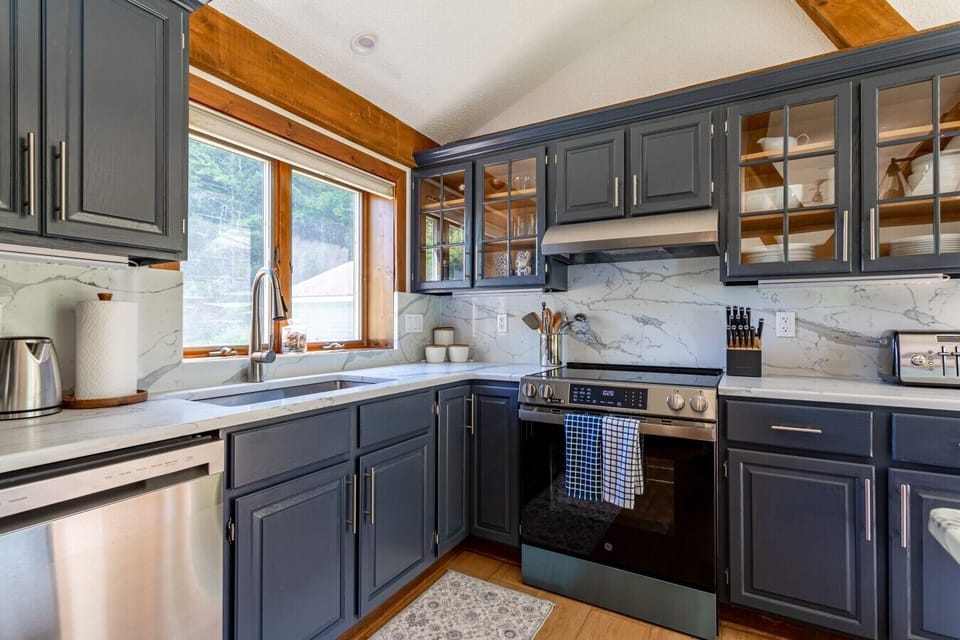 Beautiful kitchen with new stainless steel appliances and views of the garden