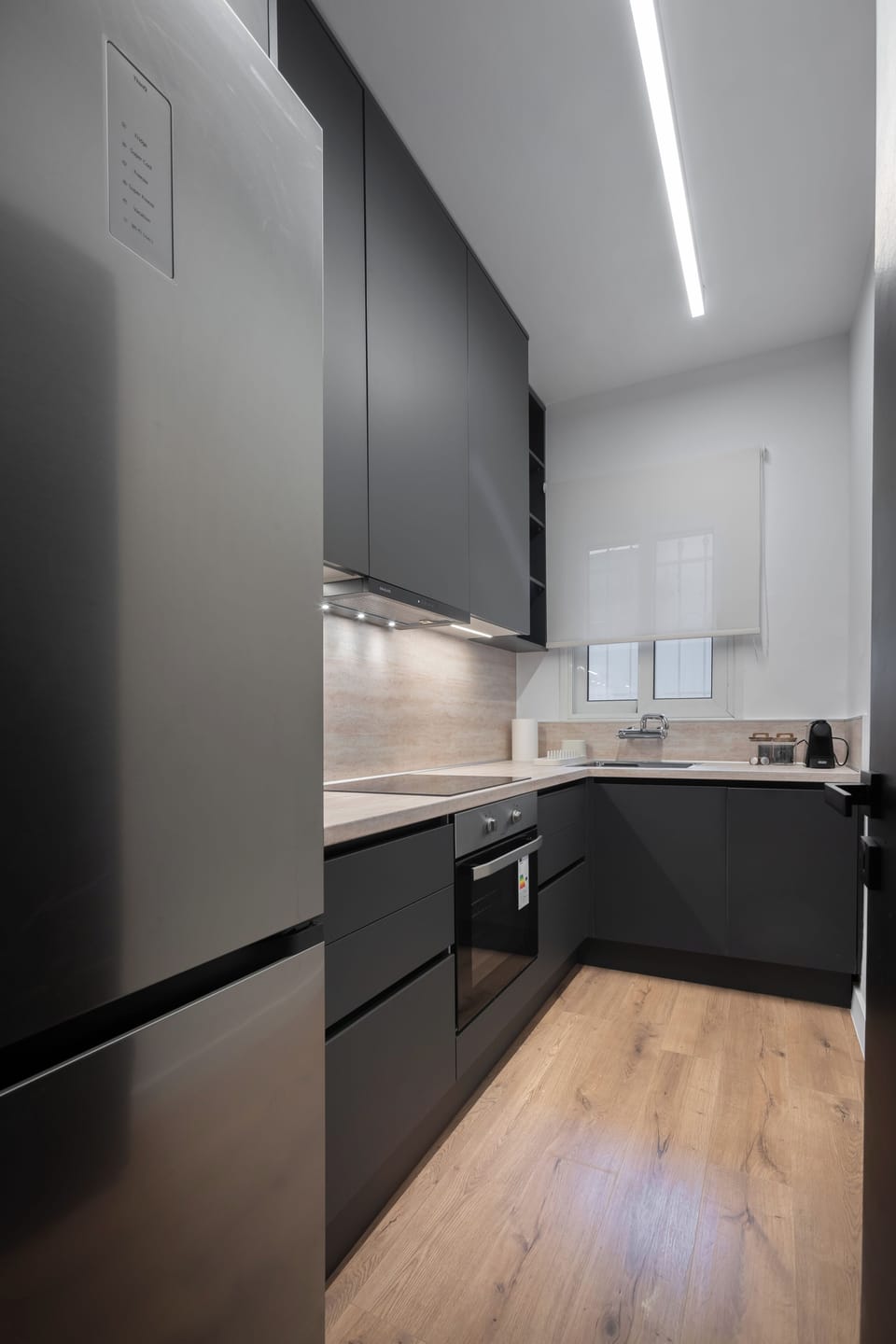 Modern kitchen with sleek grey cabinetry and minimalist design.