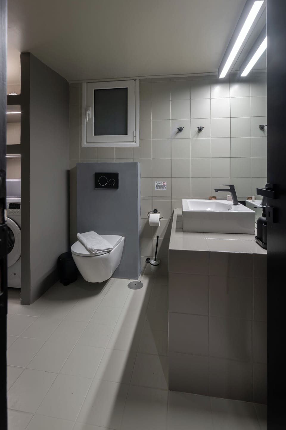 Modern bathroom with sleek fixtures and minimalist design. 
