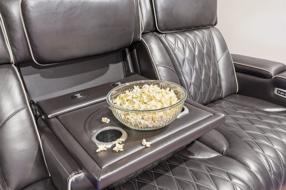Luxury leather theater seating with cup holders for cozy movie nights