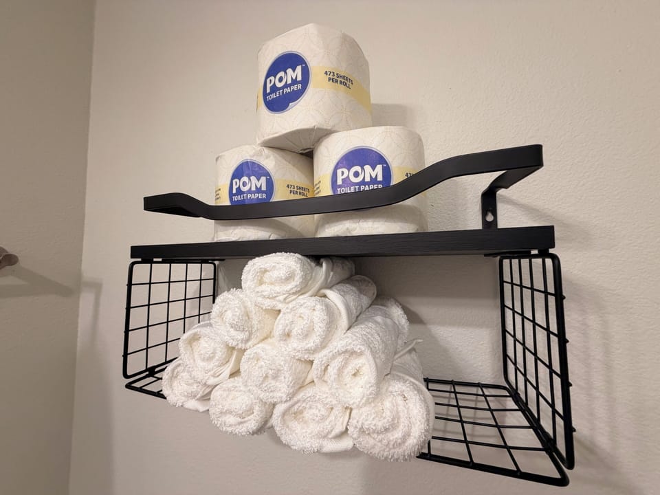 Well-stocked bathroom essentials with fresh towels and extra supplies