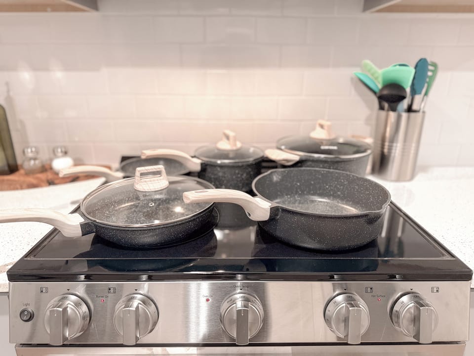 Fully equipped modern cooktop with stylish cookware and sleek finishes