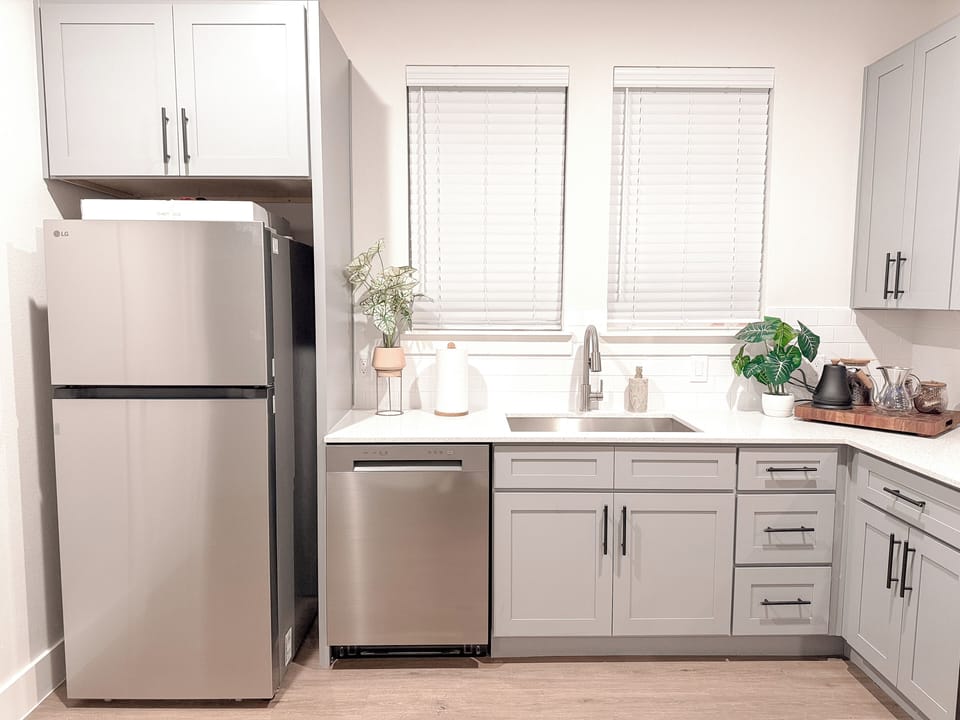 Bright modern kitchen with stainless appliances and coffee station