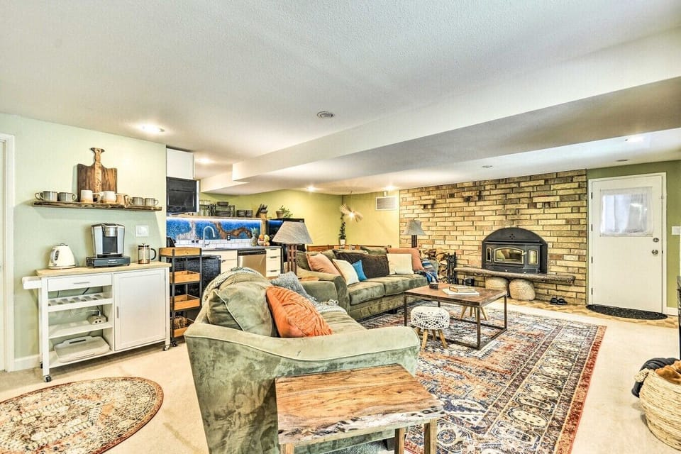 Living Room | Wood-Burning Stove | Brick Accent Wall & Kitchenette