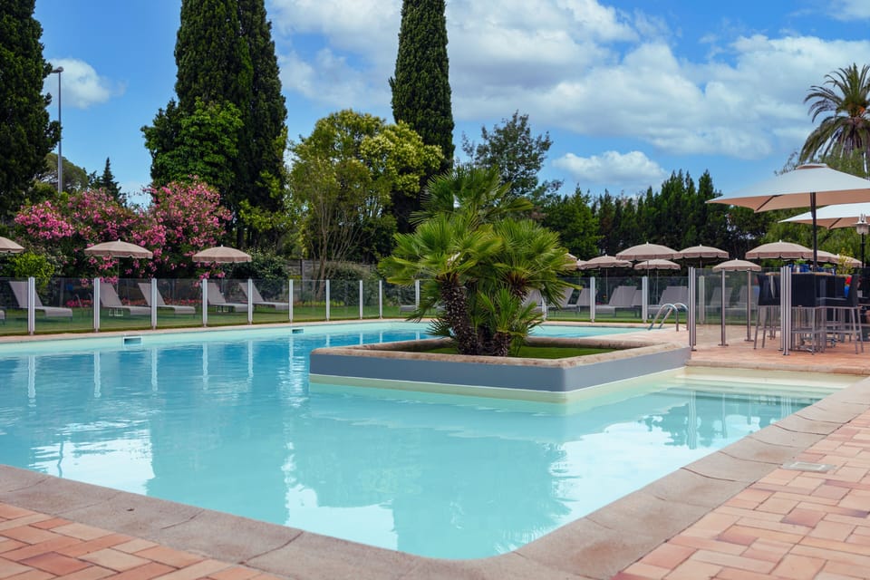 Seasonal outdoor pool, open 8:00 AM to 8:00 PM, pool umbrellas