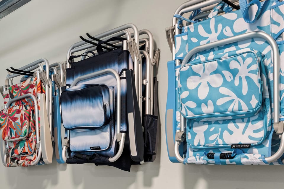 Beach day made easy! The garage is stocked with 6 beach chairs, a beach umbrella, cooler, and beach wagon.