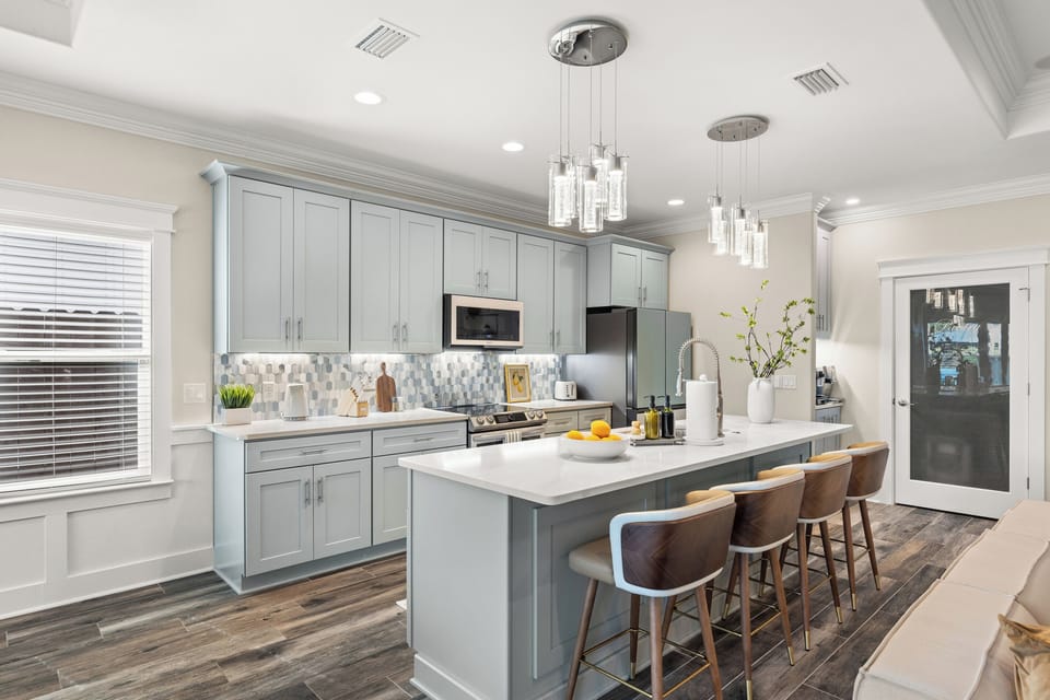 Gather around the spacious kitchen island with comfortable seating for four - perfect for morning coffee, casual meals, or keeping the chef company while dinner is prepared.