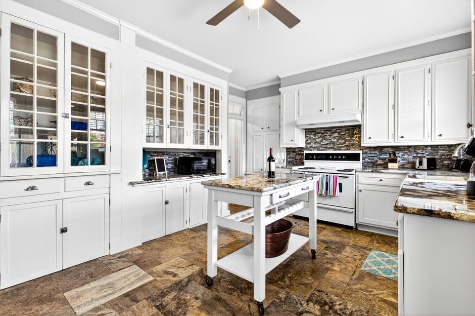Kitchen | Center Island | Glass-Front Cabinetry & Tile Flooring