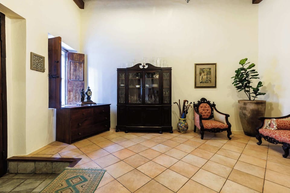 Timeless antique touches and handcrafted woodwork create a warm, museum-like welcome with a splash of Old San Juan elegance.