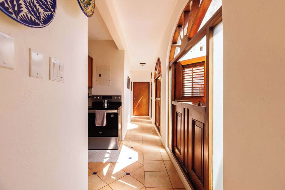 Bright and welcoming with traditional wooden accents and natural light streaming through charming arched windows.
