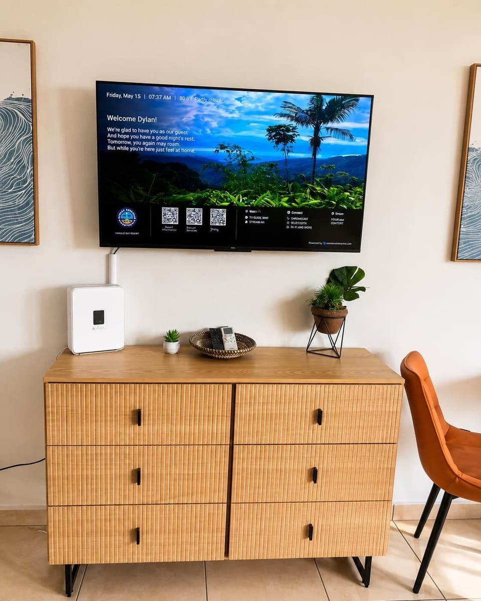 Modern and cozy living area featuring a smart TV, comfortable seating, and a stylish dining nook perfect for relaxing or enjoying a meal.