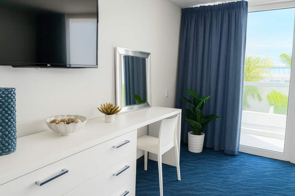 Bright and stylish workspace with natural light, modern decor, and balcony access—perfect for relaxing or catching up on work during your stay.