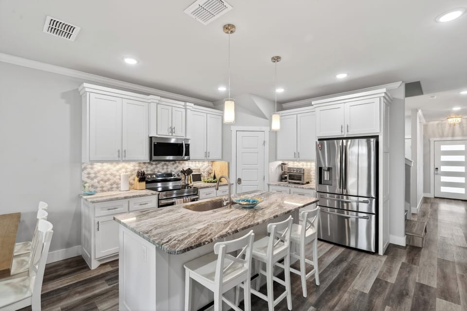 Perfect for entertaining, the great room effortlessly connects the living area, casual dining, and a gourmet kitchen.