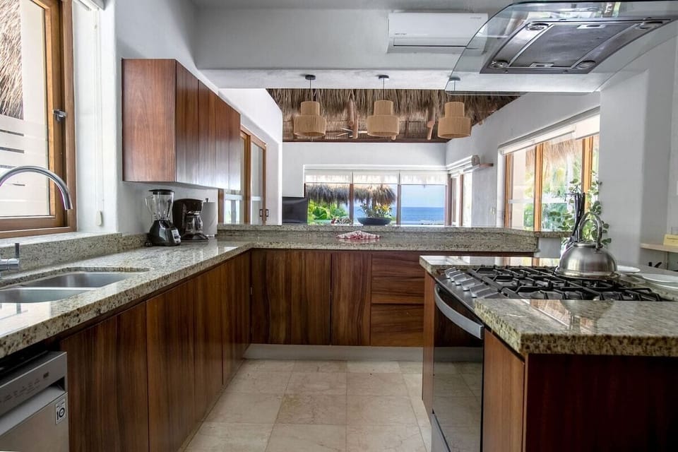 Apartment, 4 Bedrooms, Balcony, Sea View | Private kitchen | Toaster oven, freezer, paper towels, dining tables