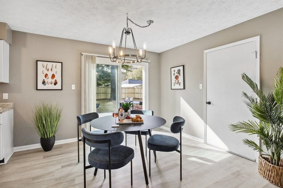 Dine with a view—this bright and airy dining area features large doors that open to the backyard patio for the perfect indoor-outdoor vibe.
