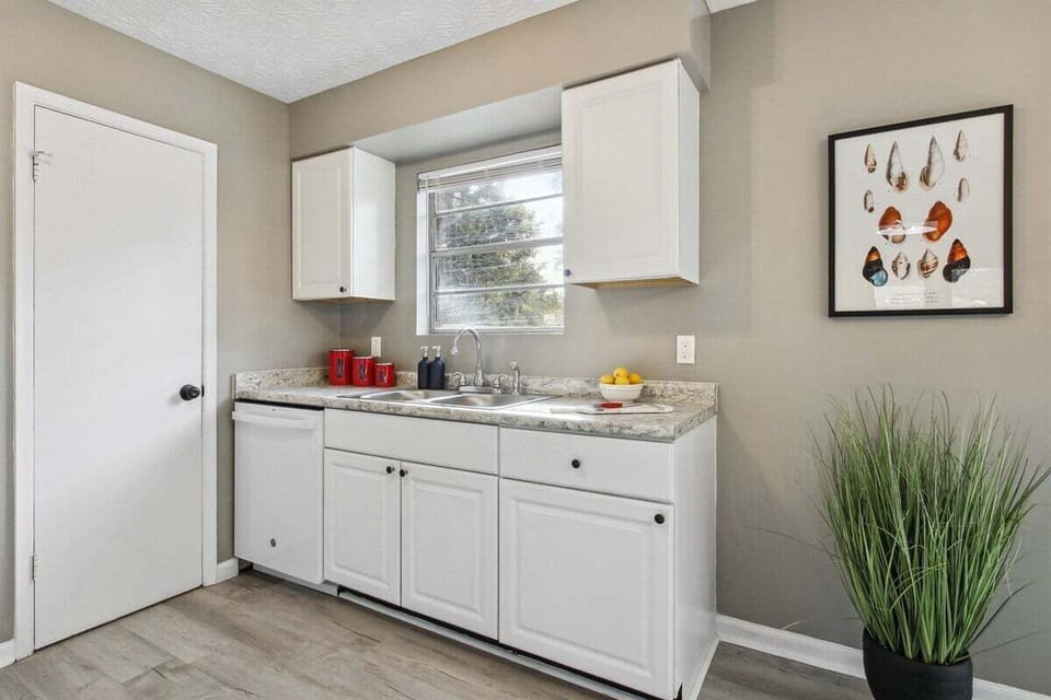 Let the sunshine in—this cheerful kitchen window fills the space with natural light and a peek into the backyard.
