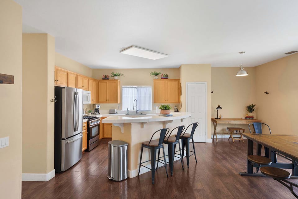 Fully stocked kitchen into open concept dining area with dedicated work space