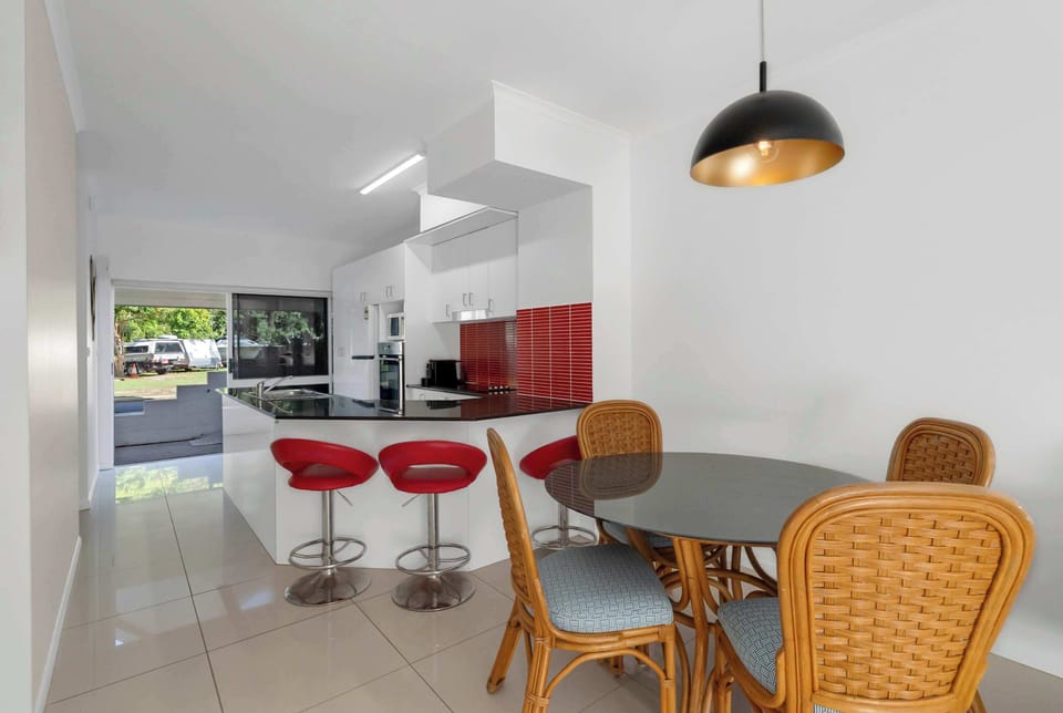 Gather around the dining area to share a leisurely breakfast, plan the day's adventures, or enjoy a meal after exploring Port Douglas.