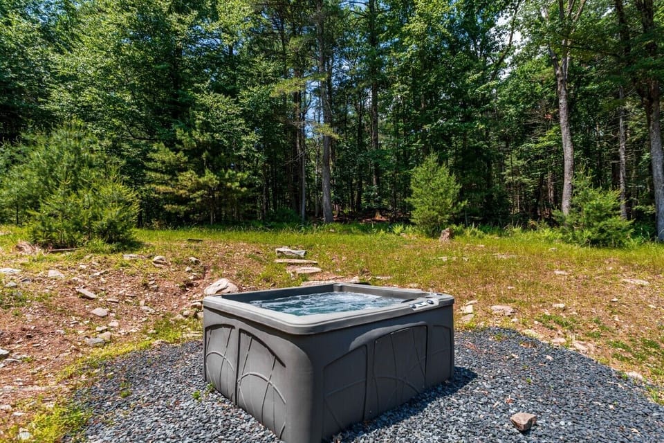 Soak under the open sky in your own peaceful woodland oasis
